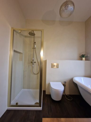 Beautifully installed bathroom with a microcement finish and brushed gold fittings, delivering a modern, luxury design with expert craftsman