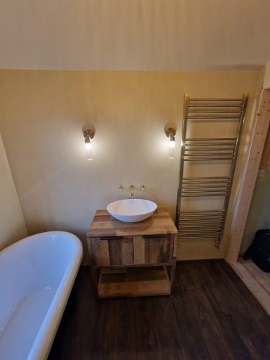 Beautifully installed bathroom with a microcement finish and brushed gold fittings, delivering a modern, luxury design with expert craftsman