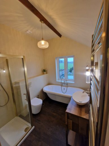 Beautifully installed bathroom with a microcement finish and brushed gold fittings, delivering a modern, luxury design with expert craftsman